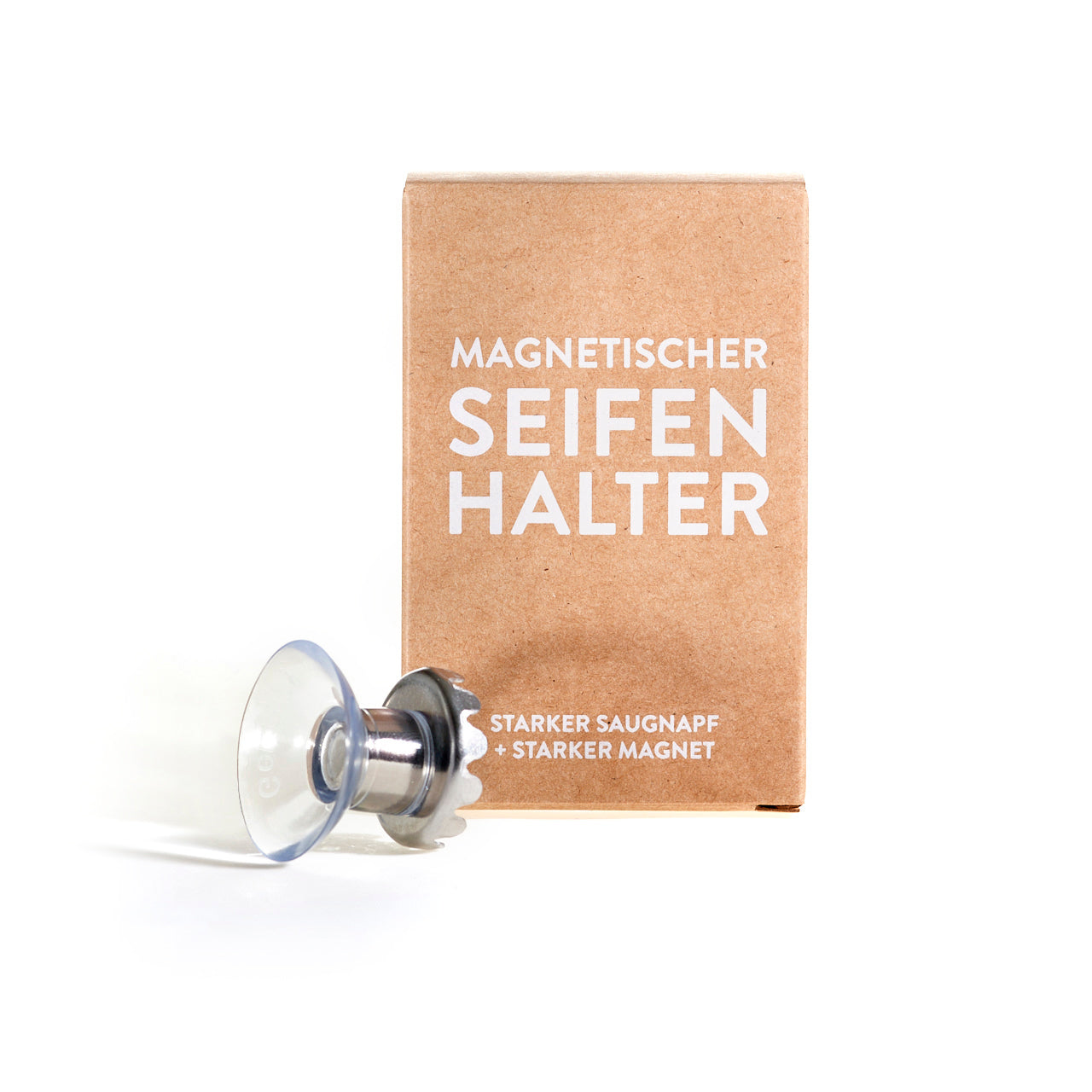 magnetischer Seifenhalter mit Saugnapf für feste Seife neben Verpackung